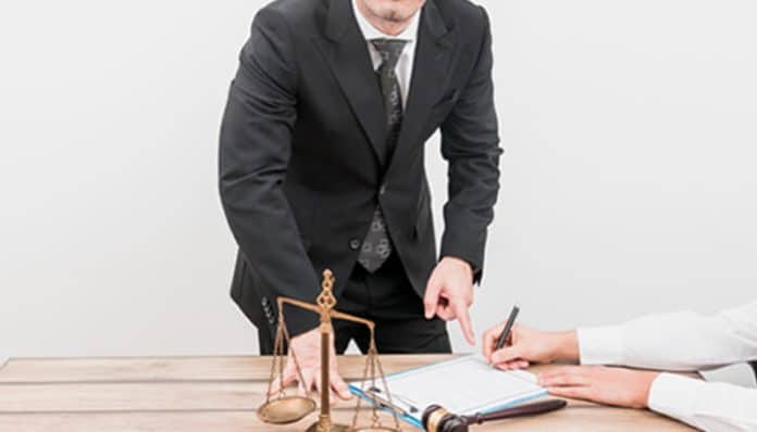 Premises liability lawyer reviewing documents and guiding a client through a legal claim.