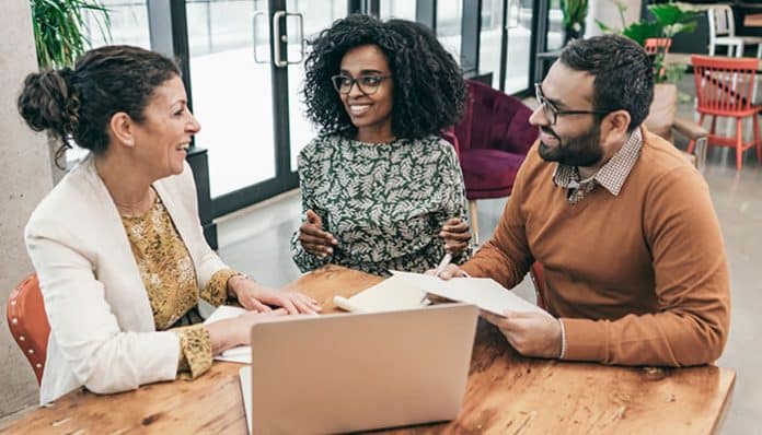 Estate planning consultation with professionals discussing legal and financial strategies for protecting assets and securing family futures.