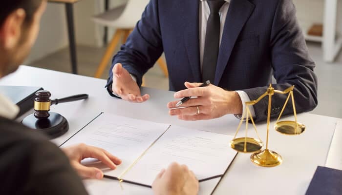 Why Legal Support Is Essential for Cyclists -myleagalopinion - My Legal Opinion A lawyer discussing documents and offering legal advice, symbolizing a consultation with a bicycle lawyer for accident-related claims.