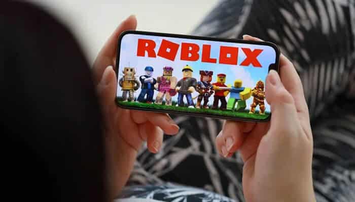 Why Specialized Help Matters - My Legal Opinion - My Legal Opinion Child holding a phone displaying the Roblox game amid ongoing concerns related to the Roblox lawsuit.