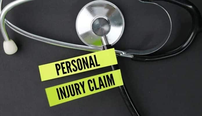 Stethoscope beside label reading Personal Injury Claim on a dark background