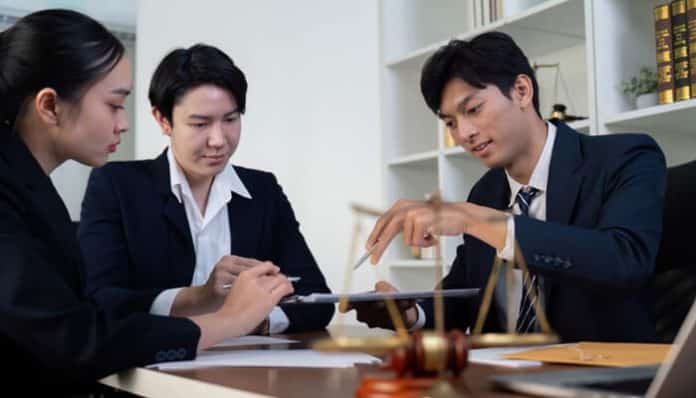 Legal professionals discussing case strategy related to systemic legal issues and policy violations