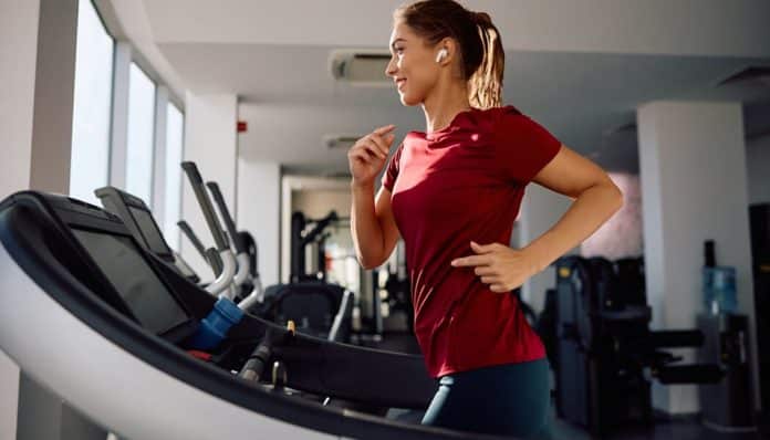 Woman running on a treadmill, possibly at risk of dizziness or falling due to Crash Diets and Dizzy Treadmills, highlighting the dangers of extreme Weight-Loss Plans that can cause falls.