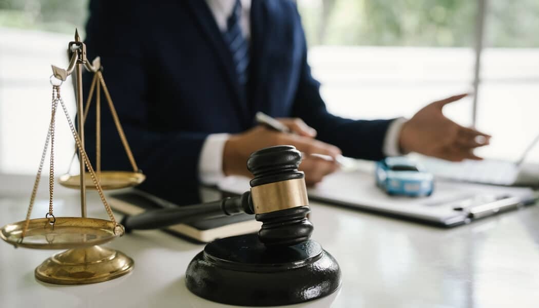 How an Attorney Maximizes Your Car Accident Claim - Mylegalopinion - My Legal Opinion Close-up of a lawyers desk with a gavel and scales of justice, representing legal assistance for car accident settlements in Florida.