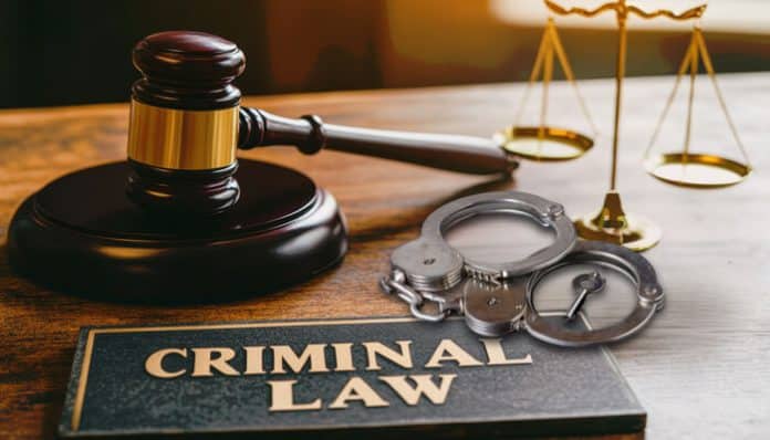 Criminal Defense Consultation concept showing criminal law book, judge’s gavel, handcuffs, and justice scales representing legal preparation