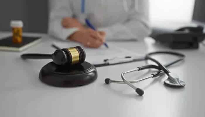 Medical Negligence And Patient Harm When Mistakes Become Legal Matters - mylegalopinion - My Legal Opinion Judge’s gavel, stethoscope, and medical documents representing legal action related to medical negligence and patient harm cases.