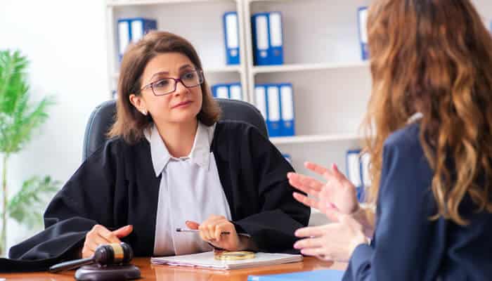 Navigating Diversion Programs and Alternative Sentencing 1 - My Legal Opinion Assault Charges in Idaho showing a defense attorney consulting with a client about legal strategy in a courtroom or law office setting