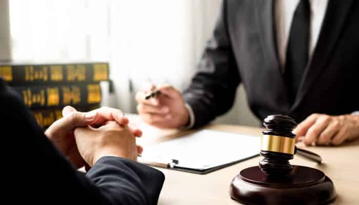 Protecting Your Rights and Building a Defense Strategy - Mylegalopinion - My Legal Opinion Attorney consulting with a client about domestic violence charges in Utah, with a gavel and legal documents on the table.