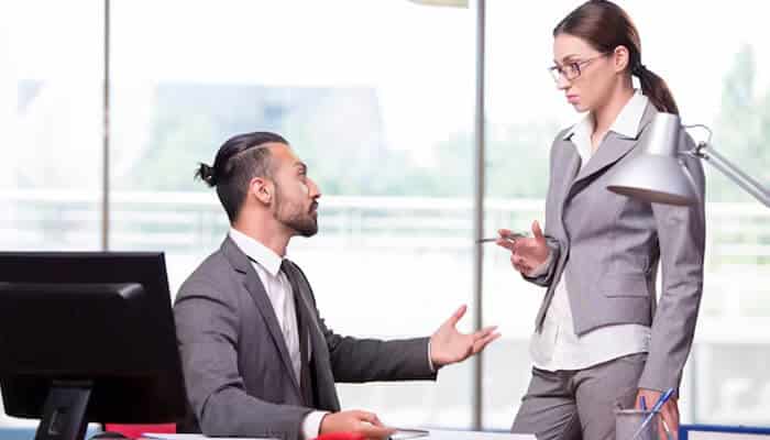 Protecting the Business During Personal Conflict - My Legal Opinion - My Legal Opinion Spousal business disputes negotiation between a couple, where both individuals are discussing business issues in a formal office setting with one person presenting their side.