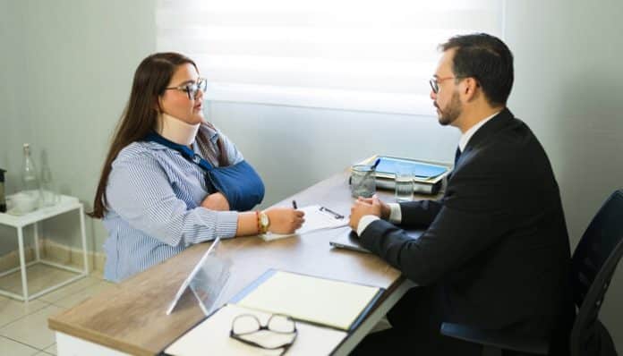 Phoenix Personal Injury Attorney consulting with an accident victim during a legal case review in an office setting.