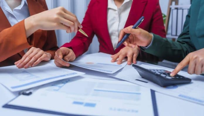 Legal and financial professionals reviewing documents related to Offshore Asset Protection Trusts and compliance planning