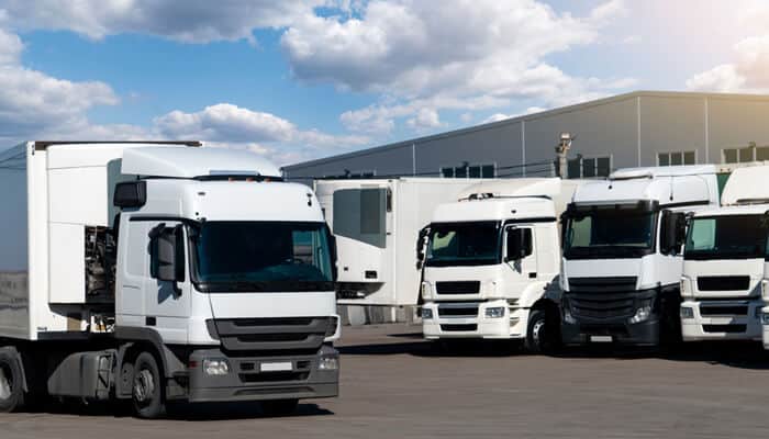 The Trucking Companys Direct and Vicarious Liability - Mylegalopinion - My Legal Opinion Fleet of trucks parked in a yard, representing the trucking companies involved in potential Texas 18-wheeler accident lawsuits.