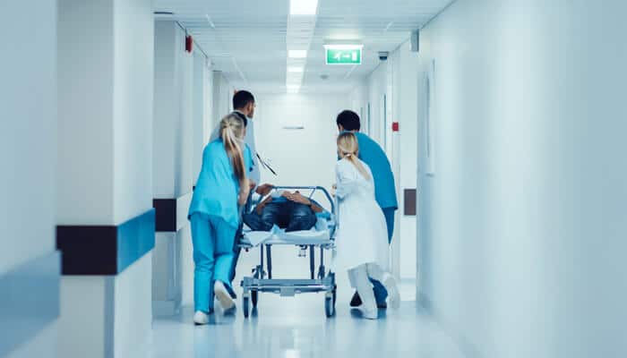 Types of Damages in an ER Error Lawsuit - mylegalopinion - My Legal Opinion Medical staff rushing a patient down the emergency room hallway, a situation that could lead to an Emergency Room Error Lawsuit due to negligence or mistakes.