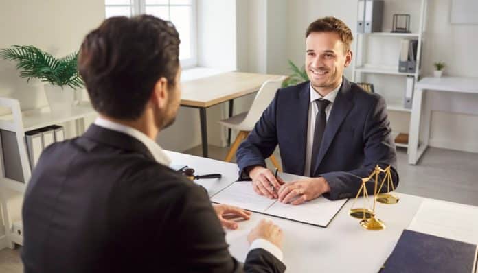 A lawyer meeting with a client in an office, discussing the types of lawyers and their roles in providing legal advice and representation.