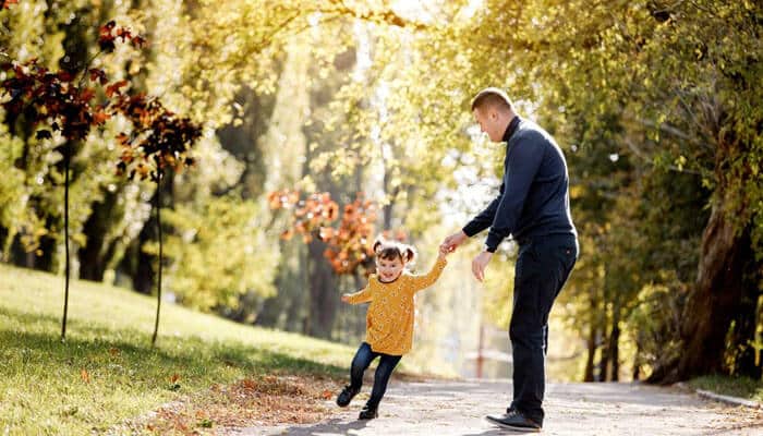 Broader Implications and Long-Term Considerations - My Legal Opinion Paternity Dispute concept showing a father holding a young child’s hand while walking together in a park