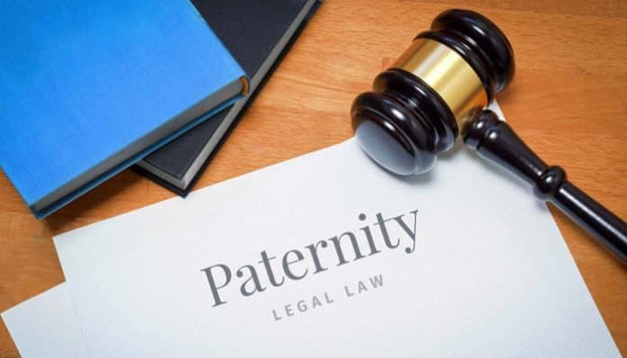Paternity Dispute legal concept with gavel, law books, and document titled paternity law