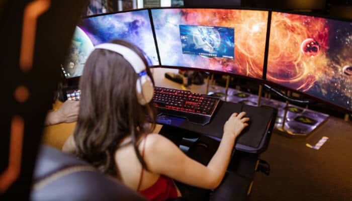 What Is the Status of Video Game Addiction Lawsuits - Mylegalopinion - My Legal Opinion Young gamer playing on multiple screens, symbolizing the growing issue of video game addiction lawsuit.