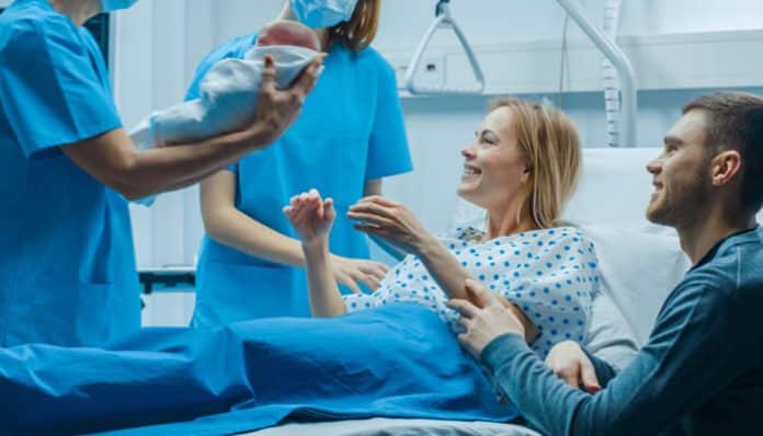 Parents and medical staff during childbirth in a hospital setting, a situation often reviewed in a Birth Injury Claim following delivery complications.