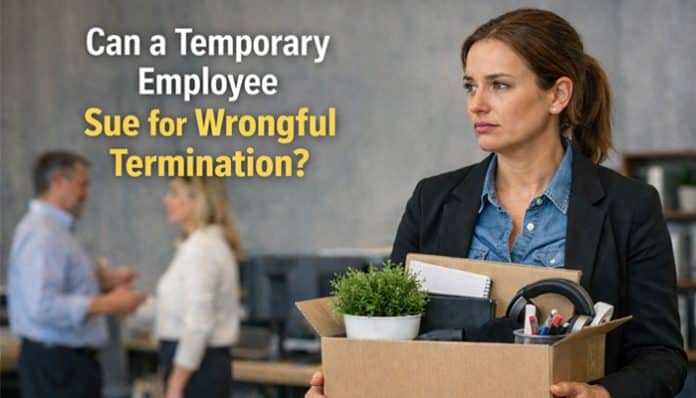 Professional woman holding a box after job termination in office setting, illustrating can a temporary employee sue for wrongful termination workplace dispute scenario.