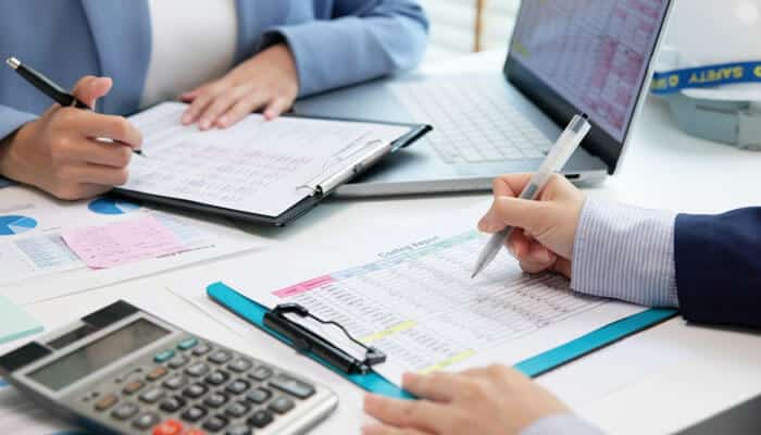 Impact on Tax Reporting and IRS Audit Readiness - My Legal Opinion - My Legal Opinion Stacks of coins symbolizing financial growth in rental property bank accounts next to a model house, representing real estate investments and income management.