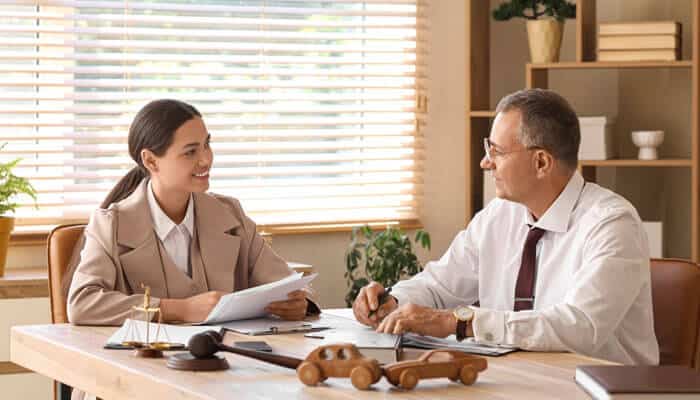 Look for Experience in Auto Accident and Injury Claims - My Legal Opinion 1 - My Legal Opinion How to Hire the Best Auto Accident Attorney shown through a consultation between an auto accident lawyer and client discussing injury claim documents