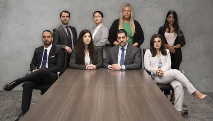 Professional legal team posing in a modern office conference room representing a Personal Injury Lawyer in Toronto, Ontario, Canada.