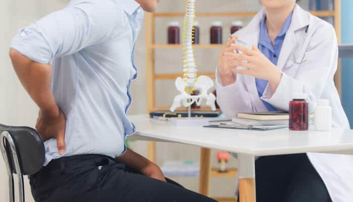 Spinal Cord Injuries - Mylegalopinion - My Legal Opinion Catastrophic Injury Lawyer assisting a client with legal paperwork and discussing their case for a serious injury claim.