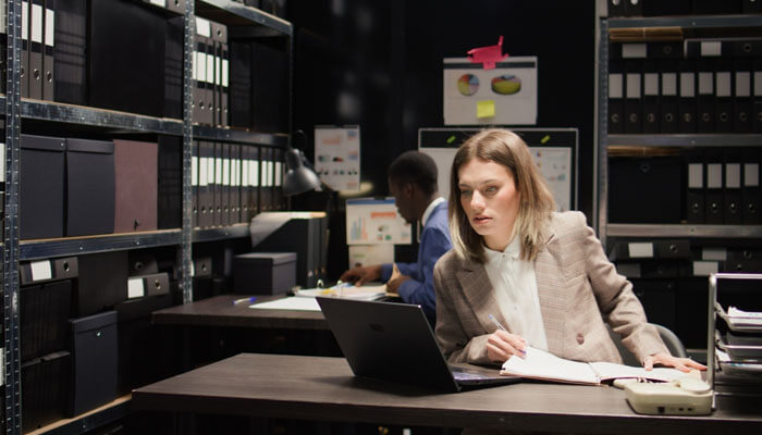 The attorneys investigation phase - My Legal Opinion - My Legal Opinion Legal professionals analyzing files and preparing evidence in an office, showcasing the detailed work involved in the Civil Personal Injury Lawsuit Process.