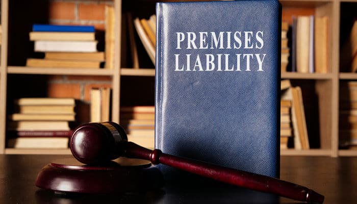What Is a Premises Liability Lawyer and When Do You Need One - Mylegalopinion 1 - My Legal Opinion Premises Liability Lawyer: A blue law book titled 'Premises Liability' next to a gavel, symbolizing legal guidance for injury claims due to unsafe property conditions.