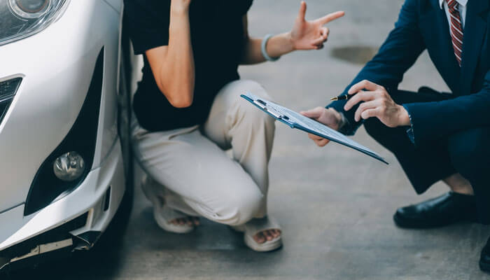 Why Consulting an Antelope Valley Car Accident Law Firm Is Crucial - My Legal Opinion - My Legal Opinion Southern California Auto Accidents: A person discussing their car accident with a lawyer, reviewing documents for a legal claim, emphasizing accident liability and compensation.