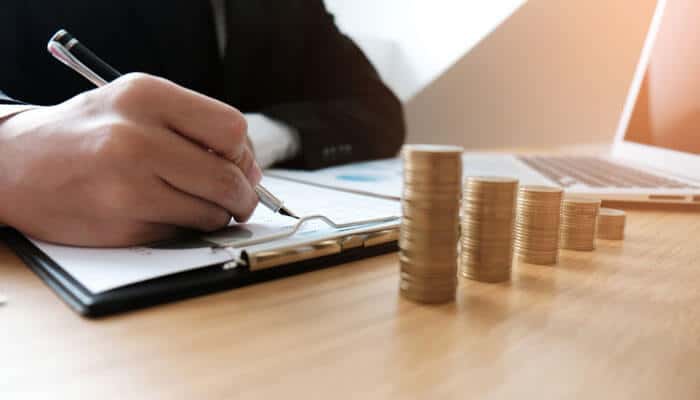 Key Drivers Behind the Demand for Audits - My Legal Opinion - My Legal Opinion Legacy Professionals LLP accountant analyzing financial data and managing growth with coin stacks and a pen.