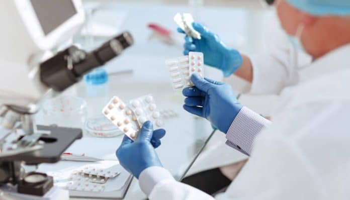 Biotech professionals analyzing pharmaceutical samples in a lab, a critical part of the innovation and regulatory processes in the pharmaceutical industry.