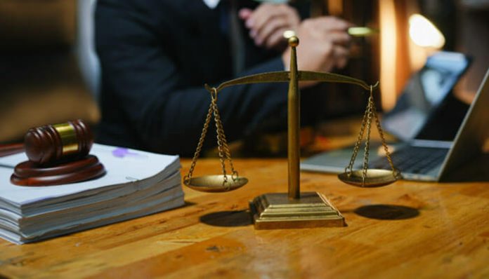 Premises liability lawyer consulting a client, with scales of justice and legal documents in the background, representing legal expertise in injury cases.