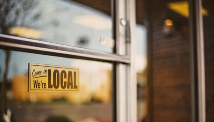 Local business storefront in Murfreesboro with a 'We're Local' sign, representing the city's thriving small business community