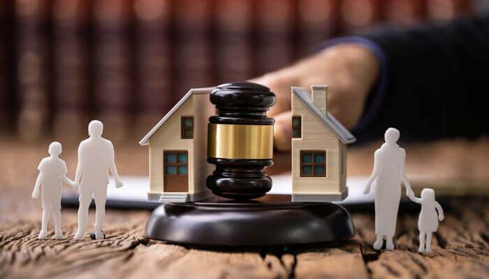 Why Context Matters in Domestic Cases - My Legal Opinion - My Legal Opinion A gavel with miniature family figures and houses, representing the role of a Domestic Violence Lawyer in handling family law matters, including custody and property disputes in domestic violence cases.