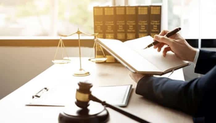 What the Appellate Ruling - My Legal Opining - My Legal Opinion AZA Law attorney writing notes in a legal notebook with gavel, scales of justice, and law books in a modern office environment.