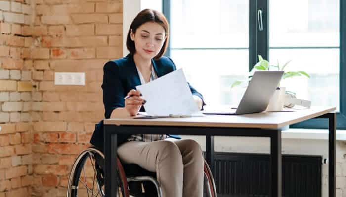 Why Hartford Disability Claims Are Denied - My Legal Opinion - My Legal Opinion Professional reviewing documents for Hartford Disability Lawsuit after disability claim denial