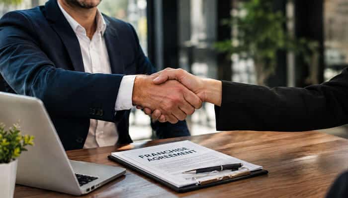 Franchisee Relationships Are Not a Side Issue - My Legal Opinion - My Legal Opinion Business agreement document and handshake representing franchise guidance from Mark Arensberg